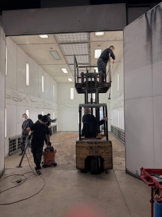 Crew member on a lift servicing booth lights and filters