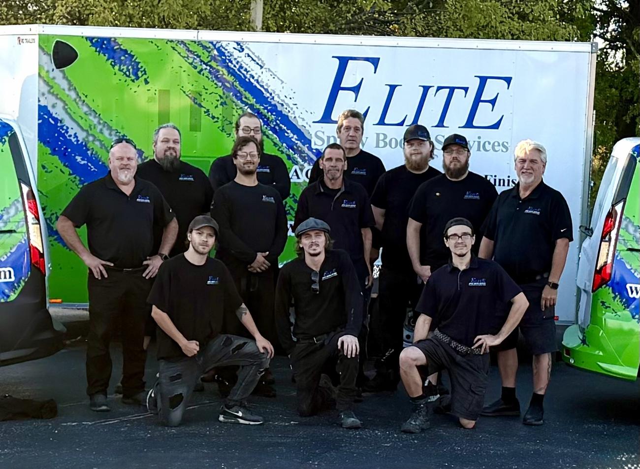 The Elite Spray Booth Services crew in front of a branded trailer