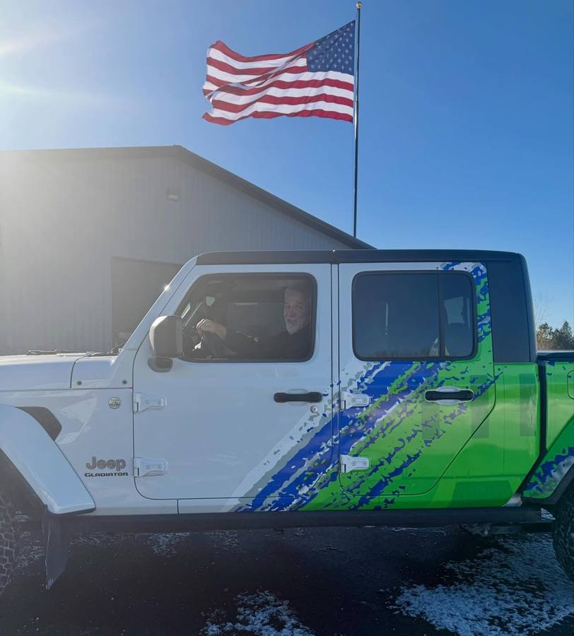 Elite branded pickup under an American flag